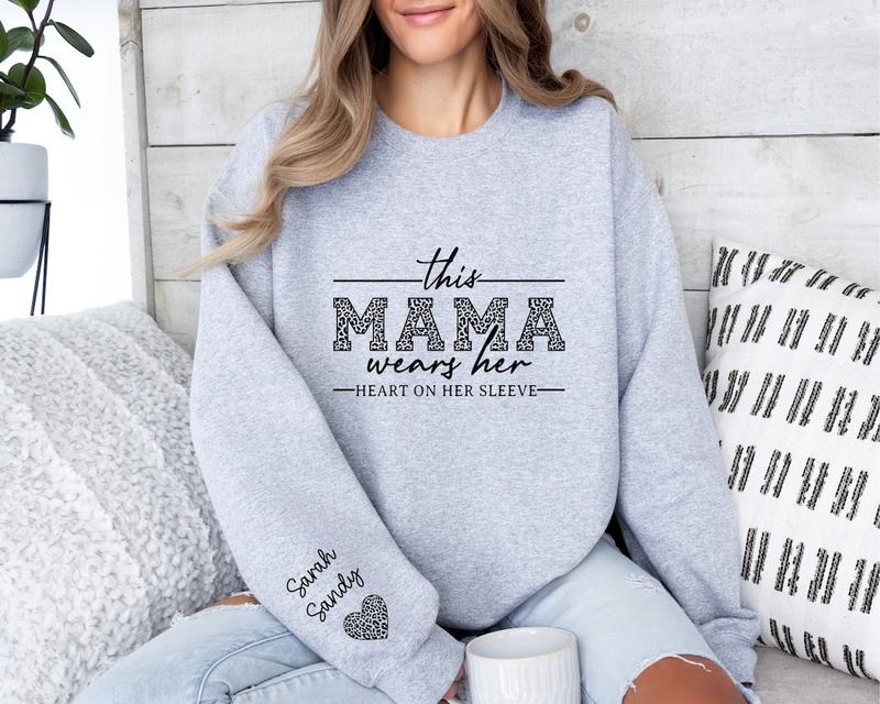 Custom Mama Sweatshirt With Kids Names On Sleeve, This Mama Wears Her Heart On Her Sleeve, Mom Christmas Crewneck Sweater, Mothers Day Gift for Mom